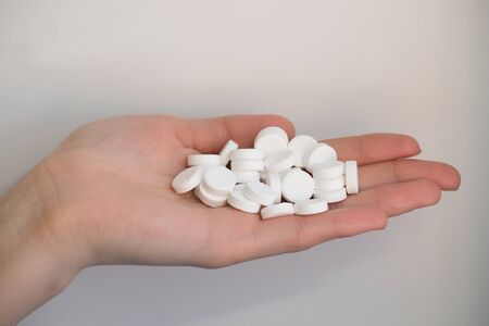Woman Hand holding pills close upの写真素材