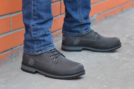 Young fashion mans legs in jeans and bootsの写真素材