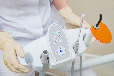 Nurse holding Dental UV curing light lamp . Ultraviolet polymerization lamp with Orange blocking glass.の写真素材