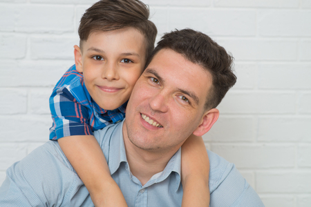 Father holding son on his shoulders, closeup portraitの写真素材