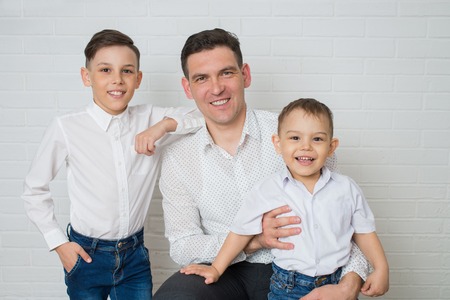 Happy Father and two Sons. Fathers day. Studio portrait over white background.の写真素材