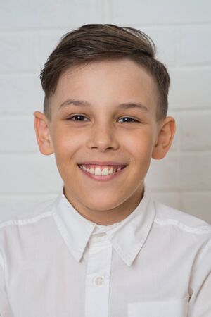 Close up Portrait of happy boy smiling on white backgroundの写真素材