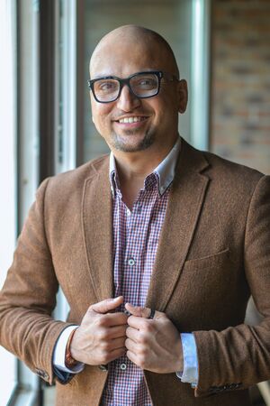 Portrait of handsome casual business Indian man with glassesの写真素材