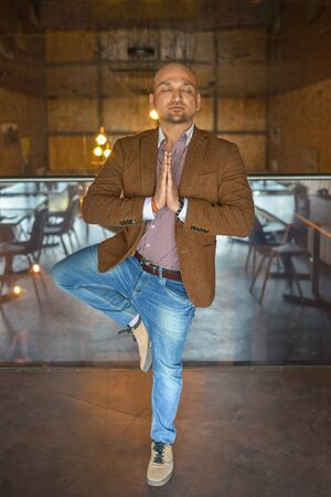 Handsome indian businessman weared in suit performing yoga or asana to relax, eyes closedの写真素材