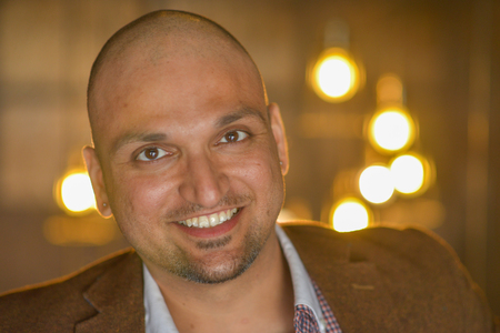 Closeup headshot portrait, happy handsome indian business man, smiling, confident and friendly indoors.の写真素材