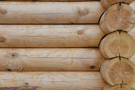 Wooden wall of the new building made of large logs, natural background.の写真素材