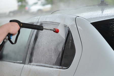 Car Wash Closeup. Washing Modern Car by High Pressure Water.の写真素材
