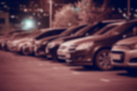 Night car parking in rows, side view. Abstract blurred background.の写真素材