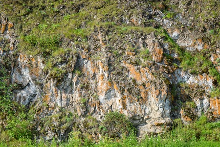 The rocks formation background texture covered with green foliage,Russia, Ural mountains.の写真素材
