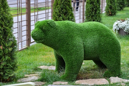 Green grass bear decorative sculpture on the lawn in gardenの写真素材