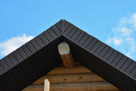 Roofing construction of wooden house closeup shot of rooftop on blue sky backgroundの写真素材