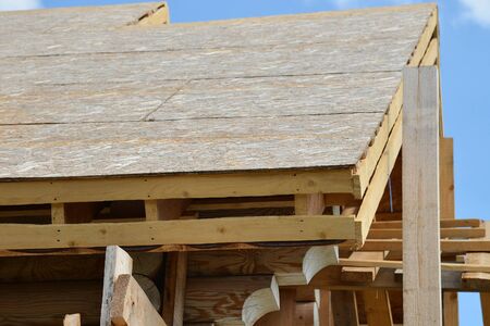 Roofing costruction of a new wooden house on blue sky backgroundの写真素材