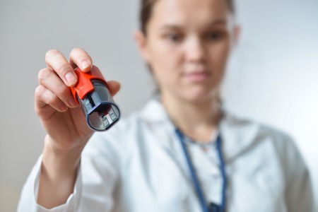 Female doctor holding rubber stamps in hand preparing to seal, closeup shoot.の写真素材