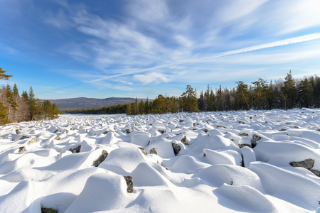 Sea of stones covered with snow, beautiful winter landscape. On the way to the mountains.の写真素材