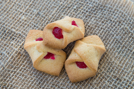 Biscuits with jam in the form of an envelope, on natural rustic background, homemade deliciousの写真素材