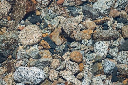Stones in river of different shape and colors, closeup.の写真素材