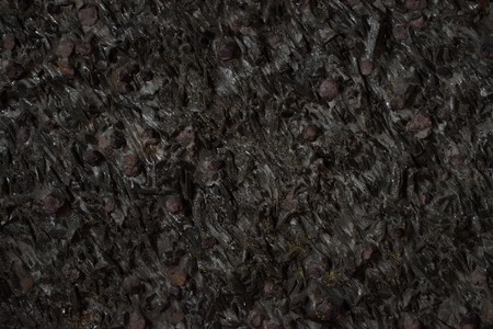 Natural black stone texture closeup, dark grey wall backgroundの写真素材