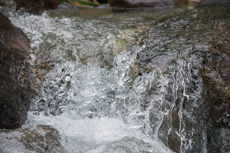 Strong boiling of water under mountain river, closeup shootの写真素材