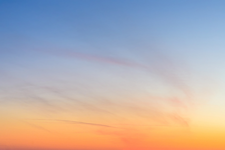 Sky and clouds at sunset, abstract colorful background, orange and blue.の写真素材