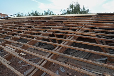 Old wooden roof under repair, roofing dismantling and renovationの写真素材