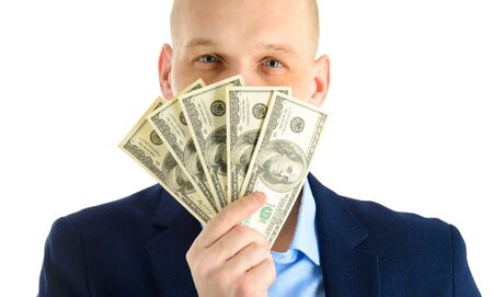 Happy handsome man in a suit holding fan of dollar banknotes, businessman and money. Isolated on white backgroundの写真素材