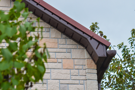Brown roof fronton of new house made of siding.の写真素材