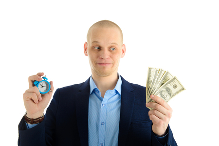 Confused Businessman with alarm clock and stack of cash in hand. Time is money concept.の写真素材