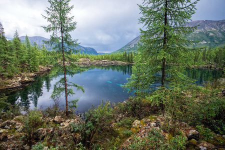Wonderful lake wide panorama. Scenic summer landscape, mountains and blue cloudy sky at background. Eastern Sayan, Buryatia, Russia.の写真素材