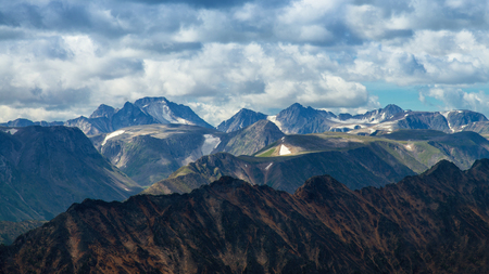 High mountains range against cloudy sky, abstract backgroundの写真素材