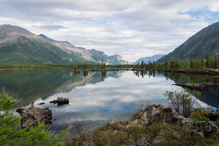 Wonderful lake wide panorama. Scenic summer landscape, mountains and blue cloudy sky at background. Eastern Sayan, Buryatia, Russia.の写真素材