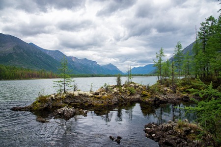 Wonderful lake wide panorama. Scenic summer landscape, mountains and blue cloudy sky at background. Eastern Sayan, Buryatia, Russia.の写真素材