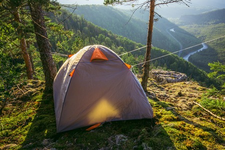 Tourist tent in camp on mountain top with beautiful view in summer morning, travel lifestyle.の写真素材