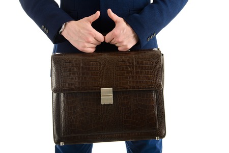 Close-up of businessman with briefcase in hands isolated on white background, thumbs up signの写真素材