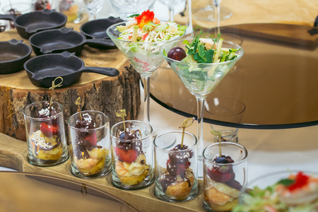 Beautiful catering banquet table with different food snacks and appetizers decorated for celebration party, closeup.の写真素材