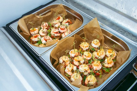 Hot Delicates, appetizer canape with tiger shrimp, fused cheese and vegetables. Catering service.の写真素材