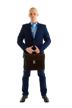 Serious caucasian businessman in suit with case standing full length portrait, isolated on white background.の写真素材