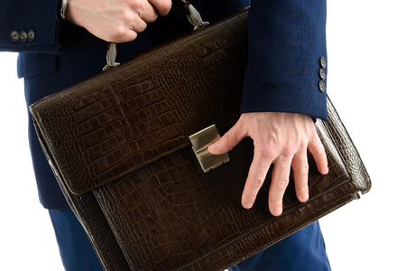 Close-up, hands of businessman holding briefcase on white background,の写真素材