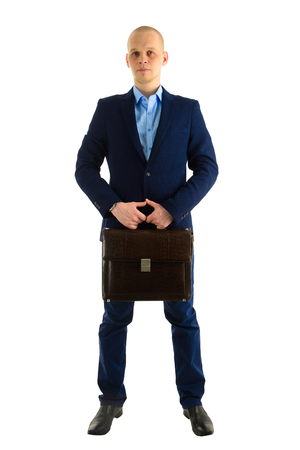 Serious Caucasian businessman in suit with case standing standing full length portrait, isolated on white background.の写真素材