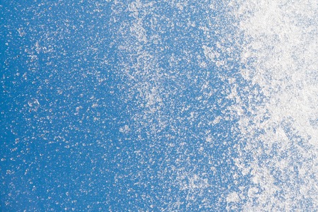 Water splashes of stream flow on blue sky background, closeupの写真素材