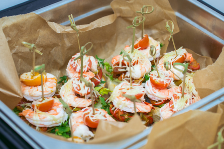 Hot Delicates, appetizer canape with tiger shrimp, fused cheese and vegetables. Catering service.の写真素材