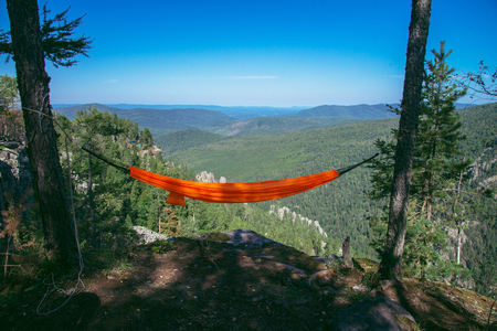 Hammock on top of mountain. Summer travel lifestyle.の写真素材