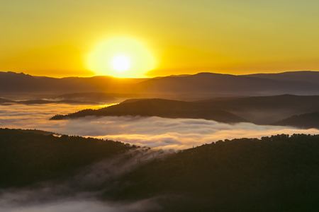 Scenic mountain landscape with Mist at summer morning, beautiful sunrise. Russia, Ural.の写真素材