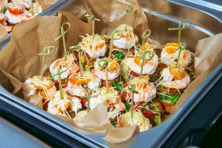 Hot Delicates, appetizer canape with tiger shrimp, fused cheese and vegetables. Catering service.の写真素材