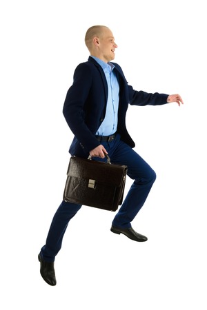 Jumping Businessman in suit with briefcase, isolated on white background, full length portrait.の写真素材