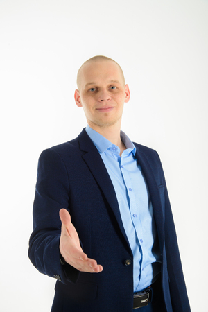 Young caucasian businessman giving hand for handshake, isolated on whiteの写真素材
