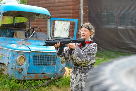 Izhevsk, Russia - June 2 2018: Young girl with a laser gun, playing lasertag shooting game, war simulation.のeditorial素材