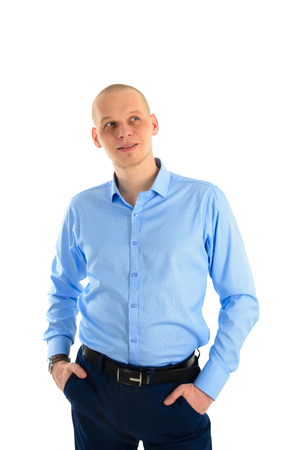 Handsome caucasian man in blue T-shirt looks thoughtfully up, isolated over white background.の写真素材
