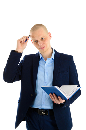 Portrait of a concentrated man in suit holding notebook and thinking, isoalted on white background.の写真素材