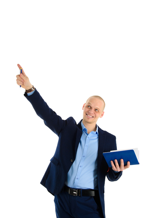 Happy young successful caucasian man suit holding a pen and notebook have new idea. Education or business theme.の写真素材