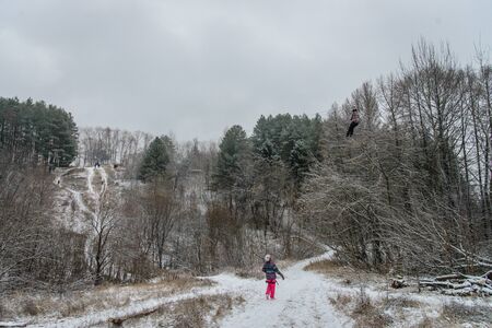 Russia, Izhevsk - November 18, 2018: Zipline. People Sliding on rope trolley over ravine on high altitude. Extreme and active leisure.のeditorial素材